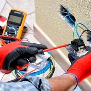 Plugs Installation Electrician fixing plugs and switches that are tripping power inside the house. with a screw driver and a multimeter to test the voltage. Electrical Wiring Repair