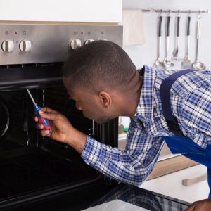 Juspropa Technician With Screwdriver Fixing Kitchen Oven not heating