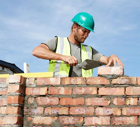 Bricklayer Juspropa Brick Layer. Building contractor laying bricks